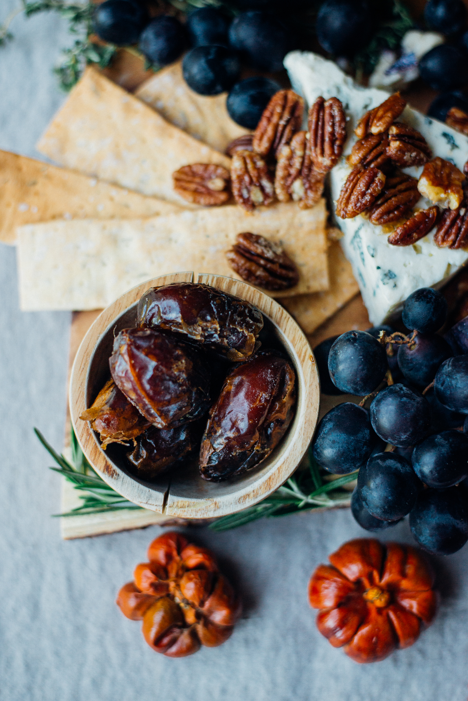 dates in small wooden bowl on fall cheese board