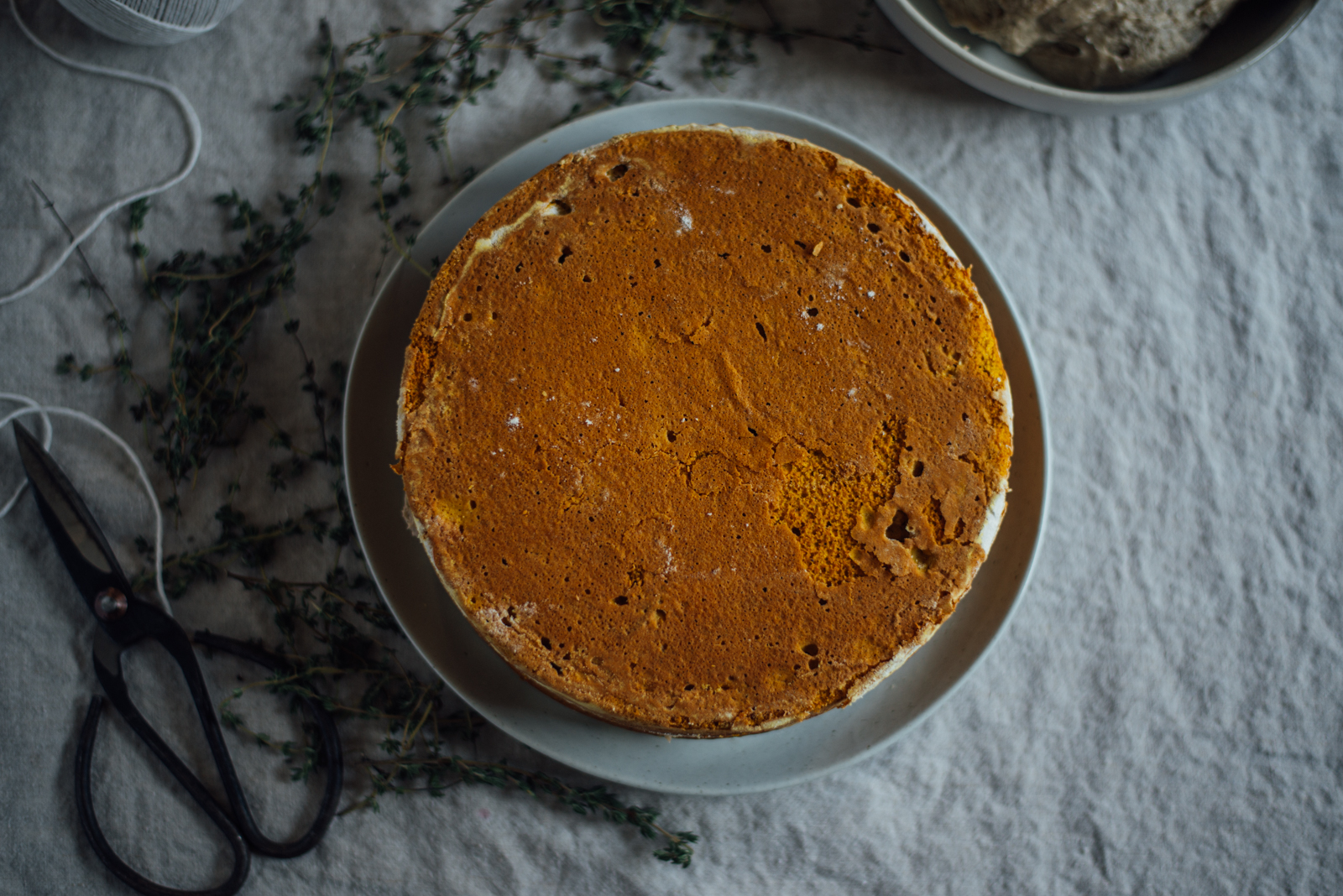 chai pumpkin cake on round plate and linen tablecloth