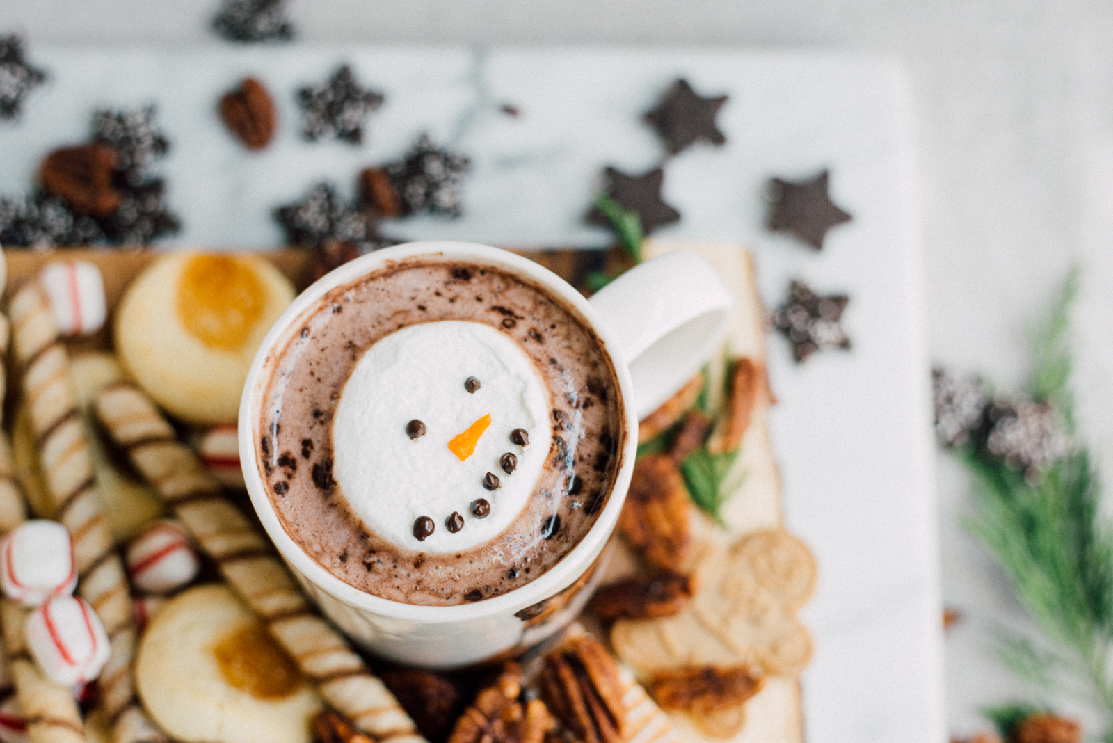 hot chocolate marshmallow snowmen on dessert board