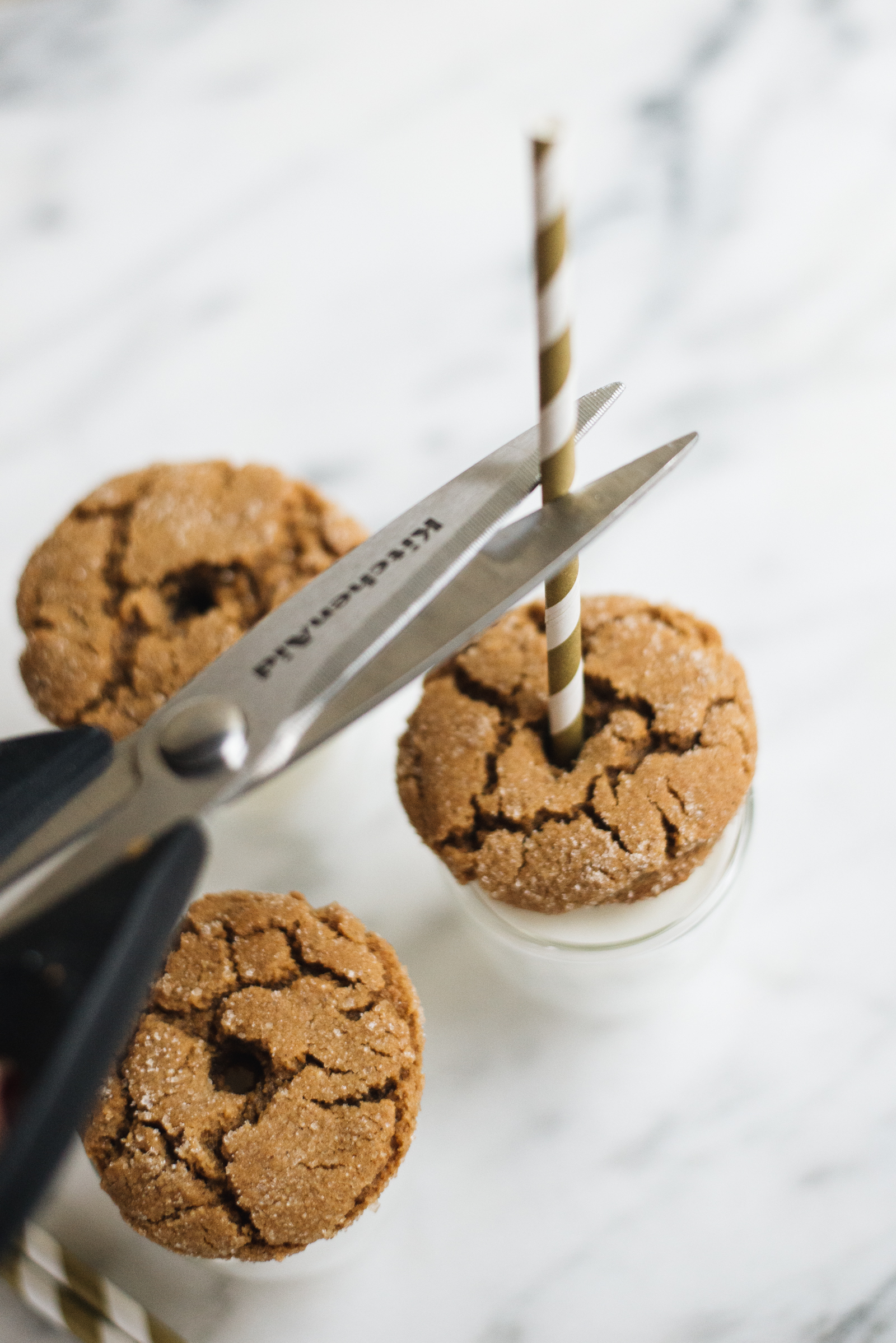 snip the gold striped straw with scissors for the gingersnap cookies