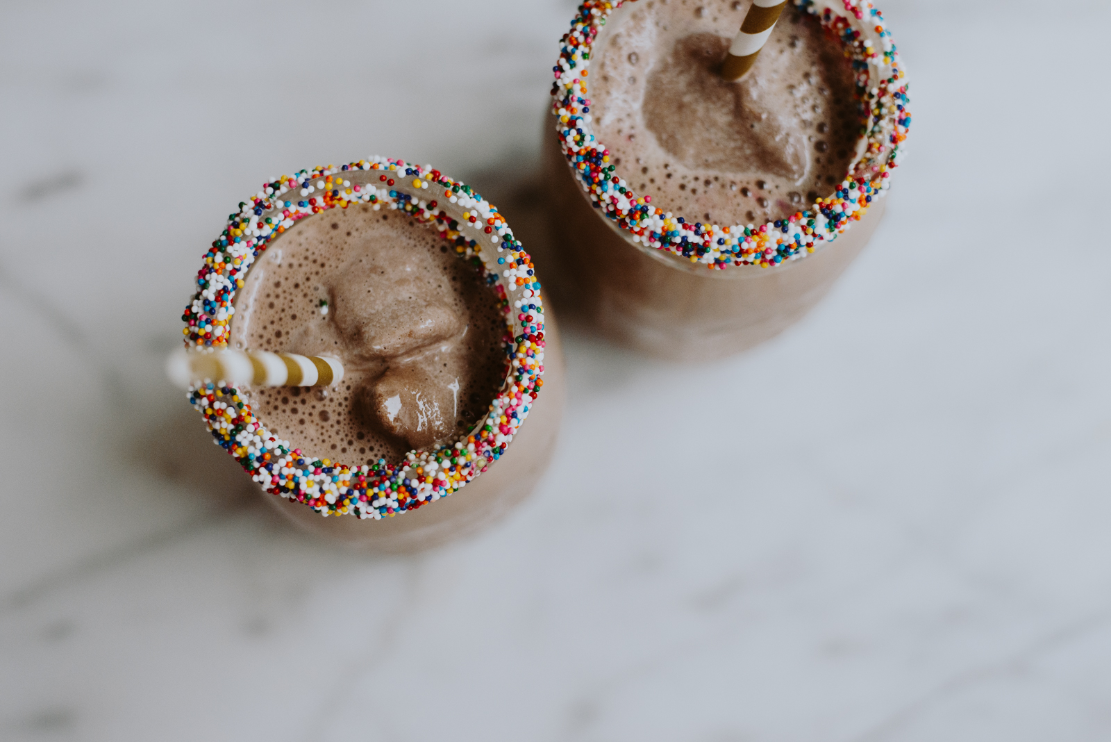 white chocolate melted on mason jar rims to hold rainbow sprinkles in place