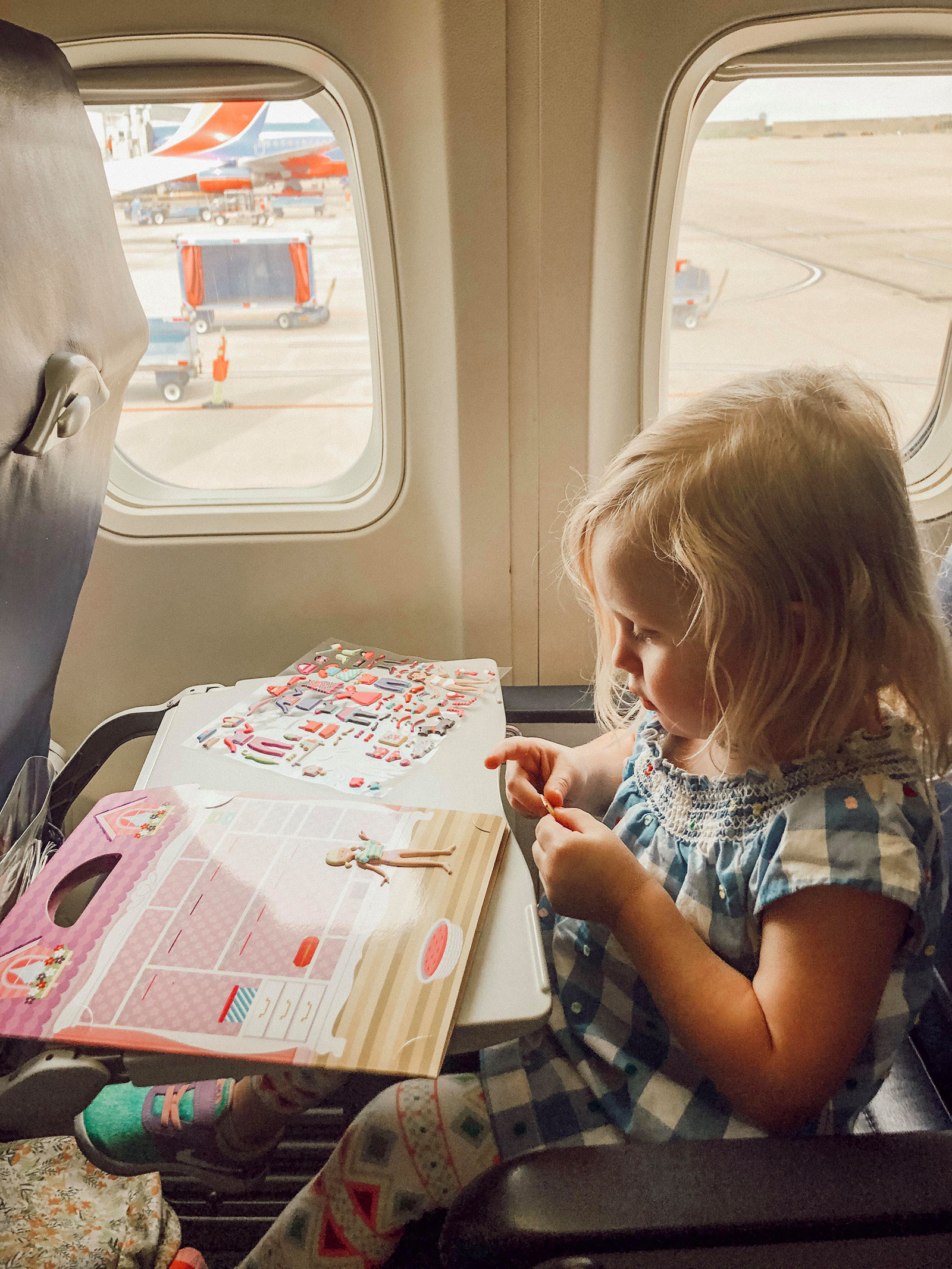 Airplane activities for kids Travel toys for children Kids travel essentials Family travel gear Traveling with toddlers Airplane tray table accessories Kids backpacks for travel Snacks for kids on planes